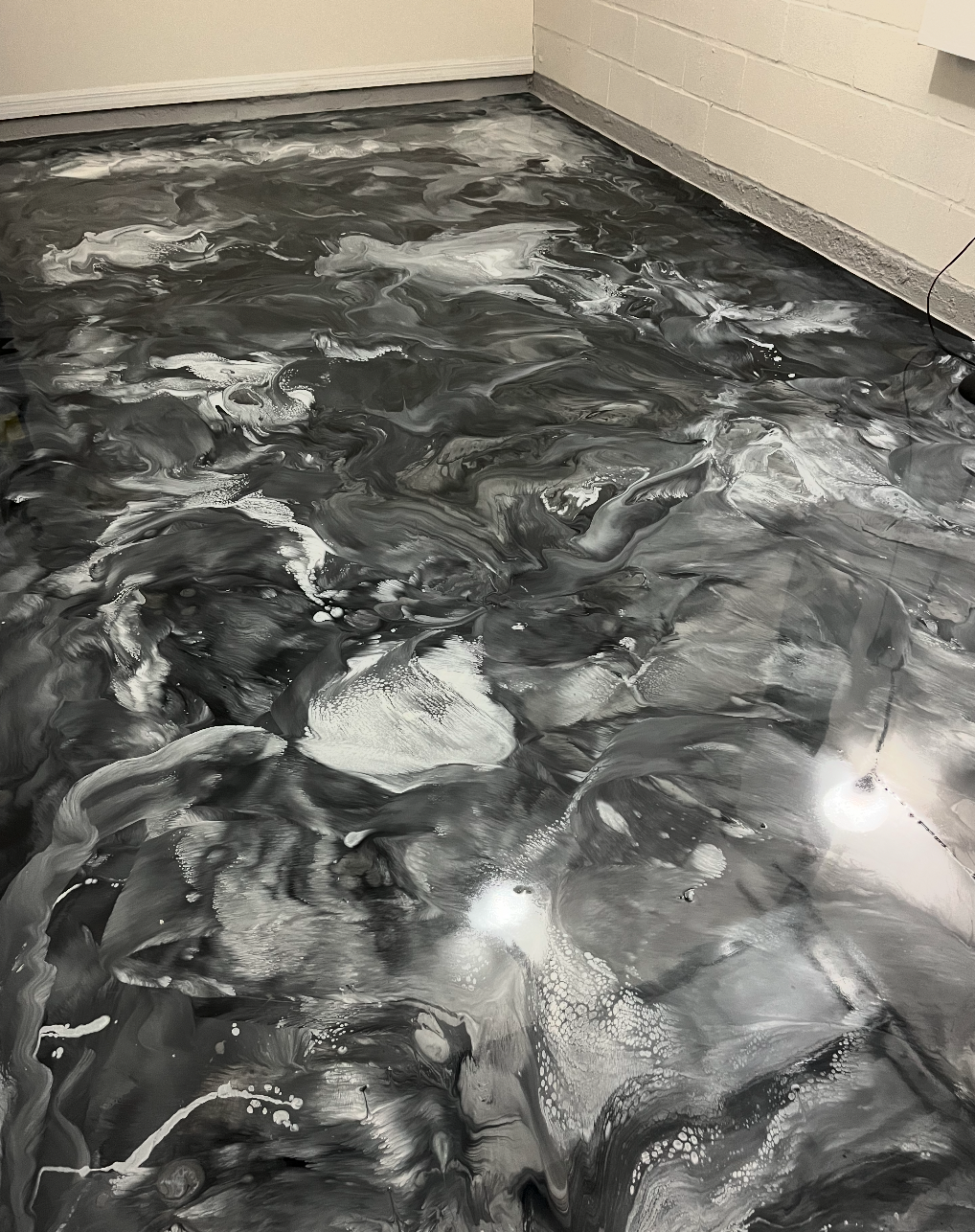 Metallic epoxy floor with high-gloss artistic movement and depth